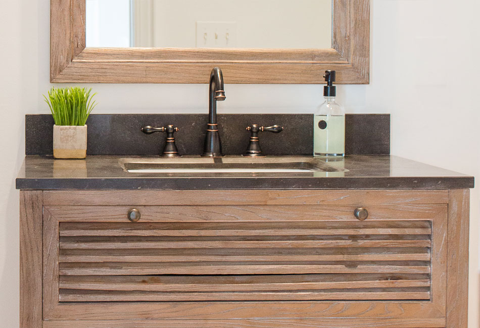 The vanity and mirror used in the powder room of The Arched Manor