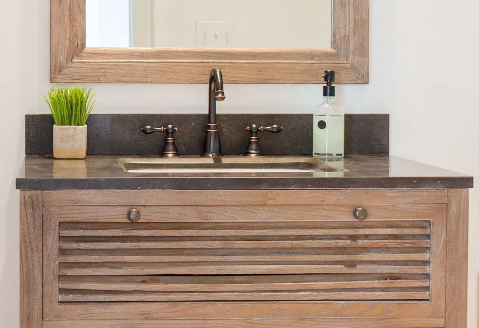 The vanity and mirror used in the powder room of The Arched Manor