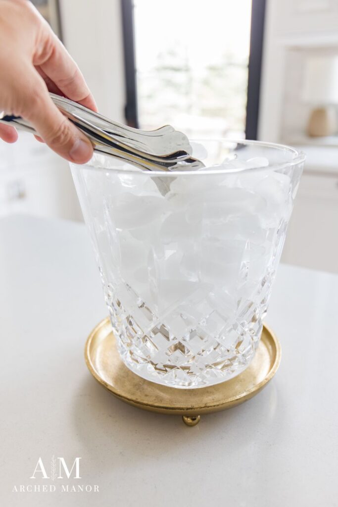 ice tongs in crystal ice bucket