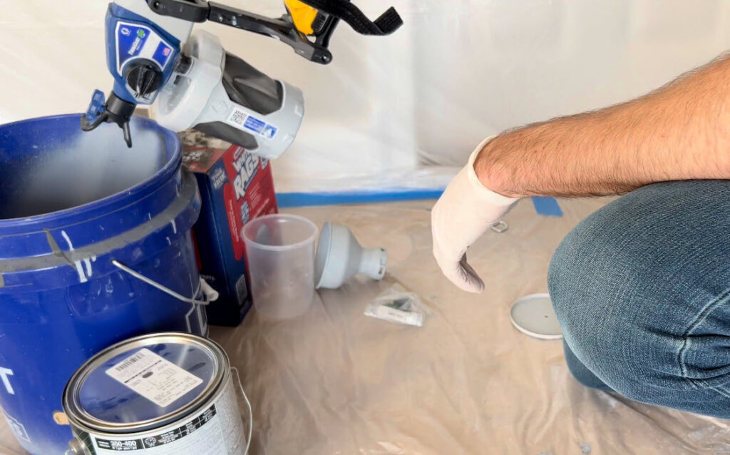 Spray in the bucket first with the tip in the backwards position, then flip the tip and spray in the bucket for a second or two.