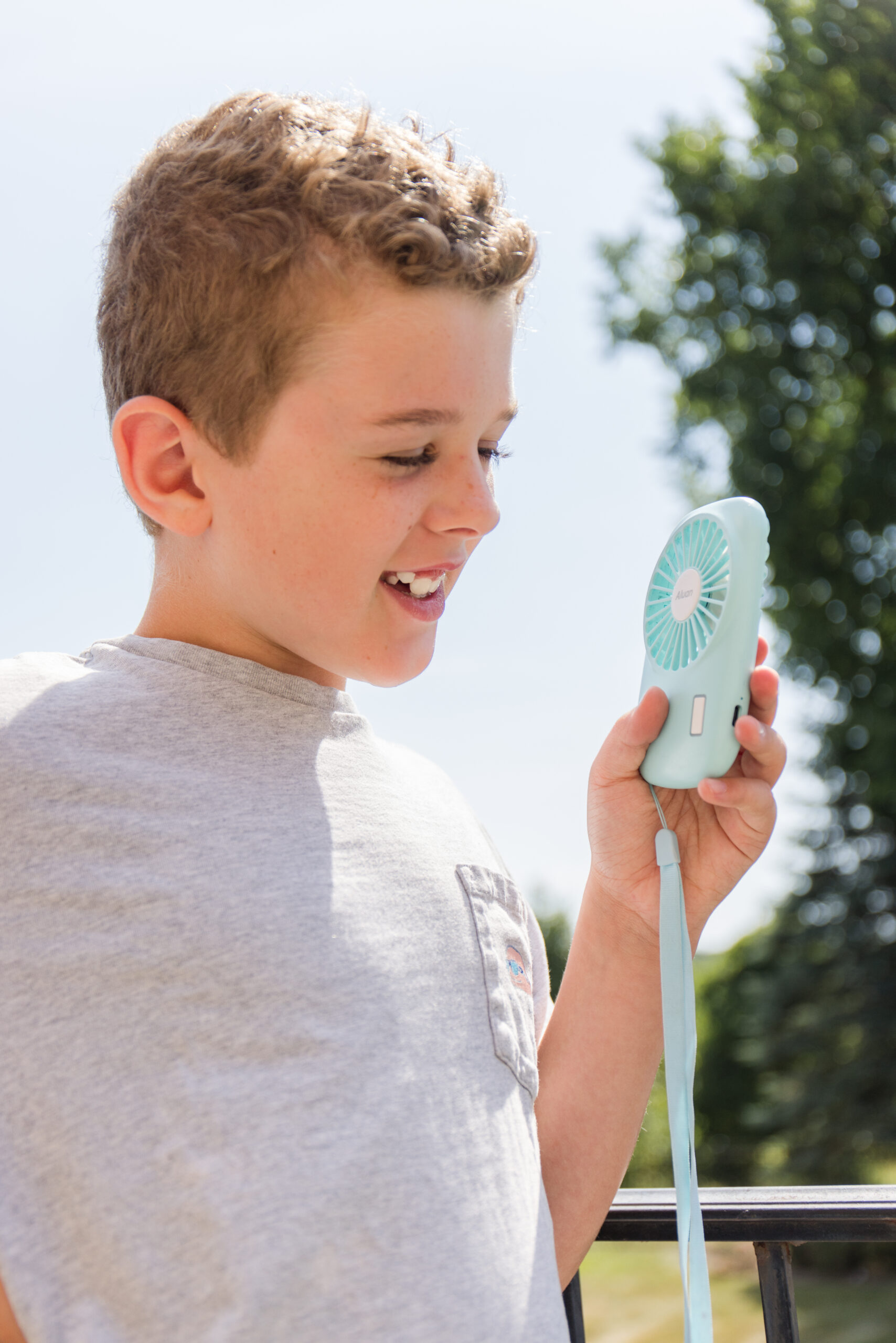 real-life image using a light blue handheld fan